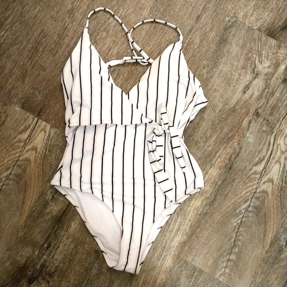 One piece suit, tag still attached